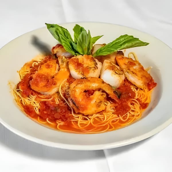 Carino's Northern Italian Cuisine's shrimp and scallop pasta with red sauce and basil.