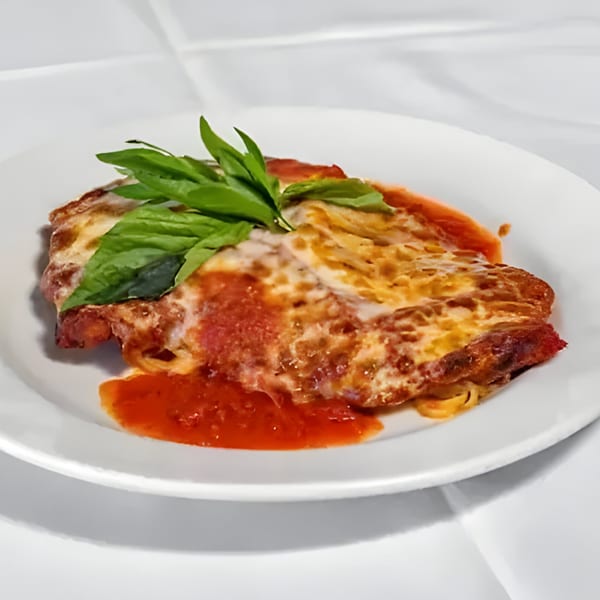 Carino's Chicken Parmesan, a breaded chicken cutlet topped with melted cheese, marinara sauce, and fresh basil.